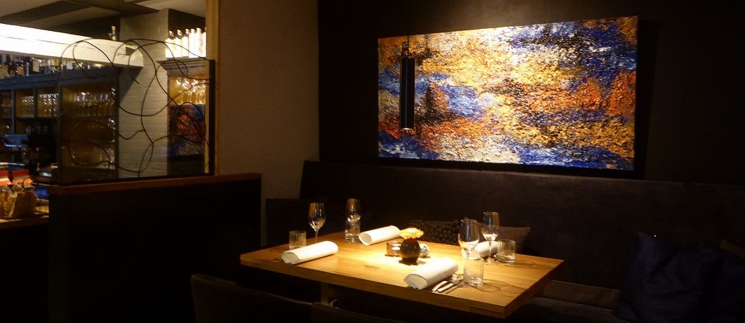 Schilderij boven de tafel in restaurant Ratatouille in Harderwijk